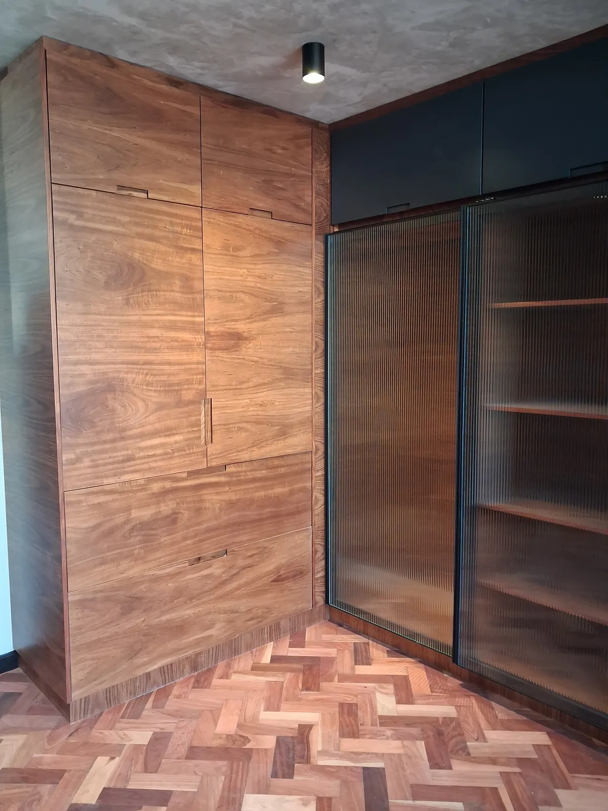 Built-in study desk and media wall unit with a slatted timber feature wall, by N.D.I.